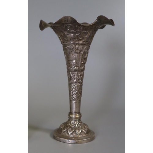 232 - White metal trumpet or bud vase with loaded base, overall with palm trees, building and animals. 13c... 