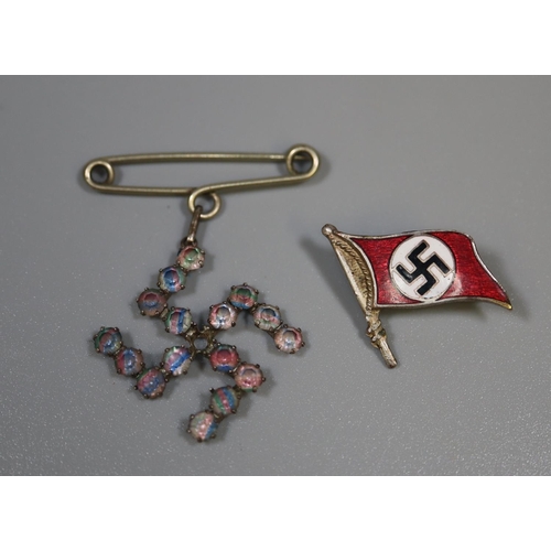 267 - An enamelled German Second World War period Swastika pin brooch and another Swastika shaped brooch. ... 