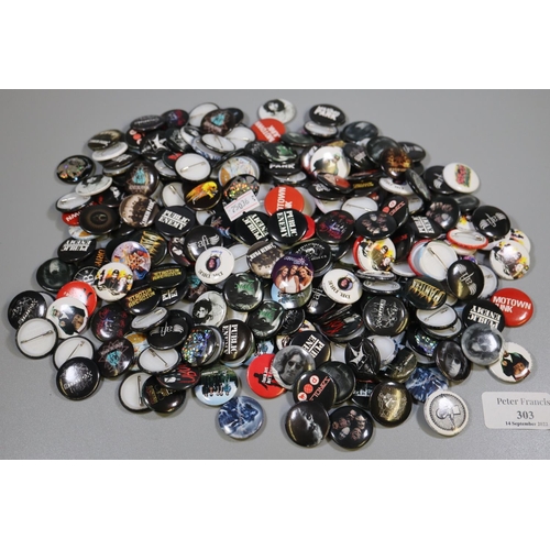 303 - Plastic tub of assorted badges to include; Public Enemy, Motley Crew, The Strokes, The Wild Hearts e... 