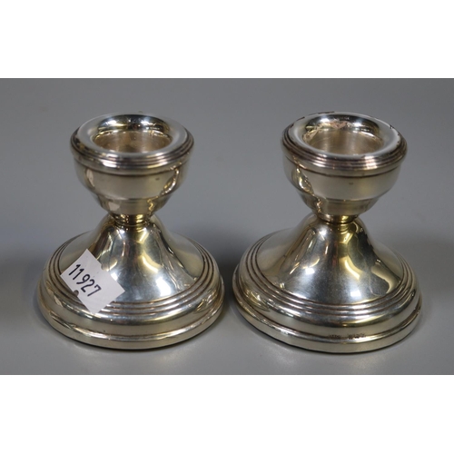 307 - Pair of silver dwarf candlesticks with loaded bases, Birmingham hallmarks. 6cm high approx. 
(B.P. 2... 