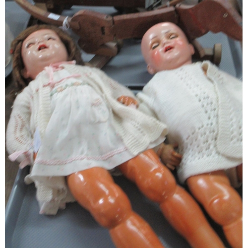 405 - Two mid Century plastic dolls with movable limbs, together with a wooden toy sausage dog on wheels a... 