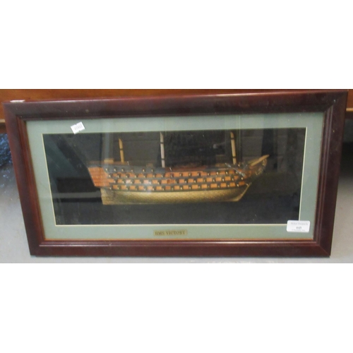 445 - HMS Victory, a reproduction half block model study in glass case, framed. 
(B.P. 21% + VAT)