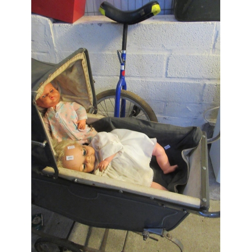 515 - H. Schutte vintage unicycle, together with a vintage toy pram and dolls.
(B.P. 21% + VAT)