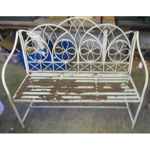 520 - Weathered wrought iron garden two seater bench, the back with flower head and geometric decoration. ... 