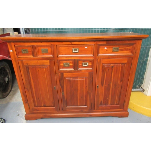 523 - Modern acacia wood sideboard or cabinet with four drawers and three shelved cupboards. Recessed bras... 