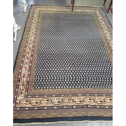 525 - Middle Eastern design navy ground carpet. Overall with floral and geometric decoration 294x196cm app... 