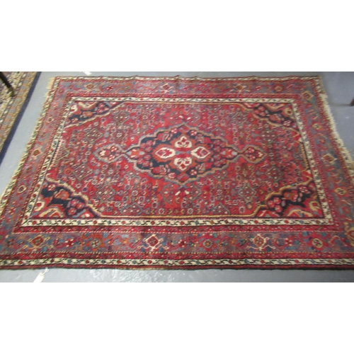 526 - Middle Eastern design red ground carpet with central lozenge medallion flanked by flowers, foliage a... 