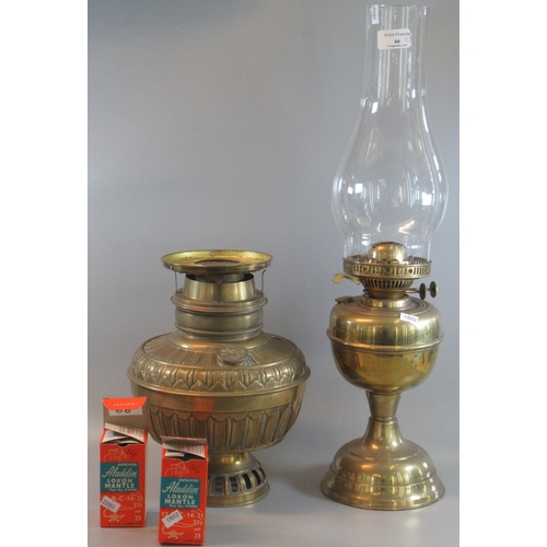 66 - Early 20th Century double oil burner lamp with glass chimney and brass base. Together with another b... 