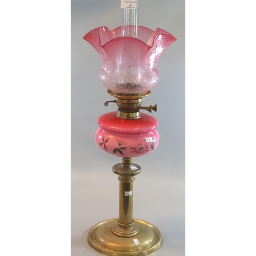 69 - Early 20th Century double oil burner lamp base,  having frosted etched foliate cranberry shade, pink... 