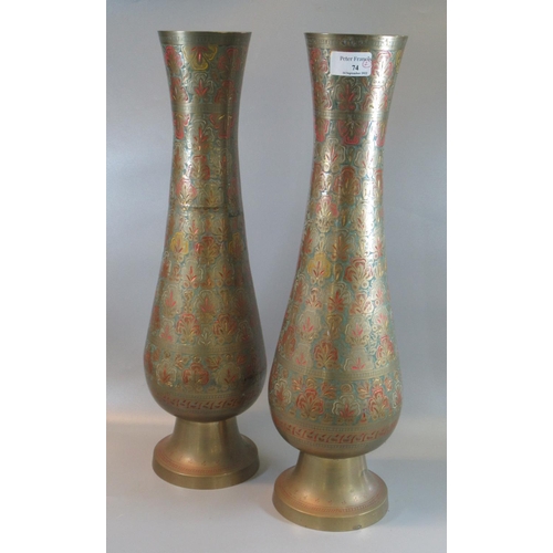 74 - A pair of brass Indian tall vases decorated with multi-coloured flowers. 
(B.P. 21% + VAT)