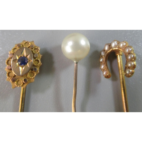 245 - 15ct gold horseshoe seed pearl set stick pin, another pearl stick pin and a 9ct gold stone set stick... 