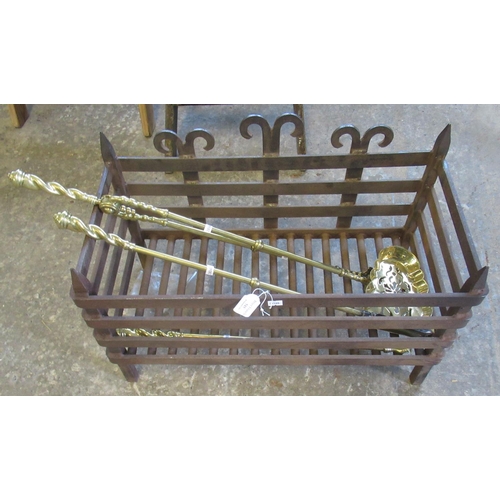 515 - Wrought iron dog grate, together with a set of three brass fire irons.
(B.P. 21% + VAT)