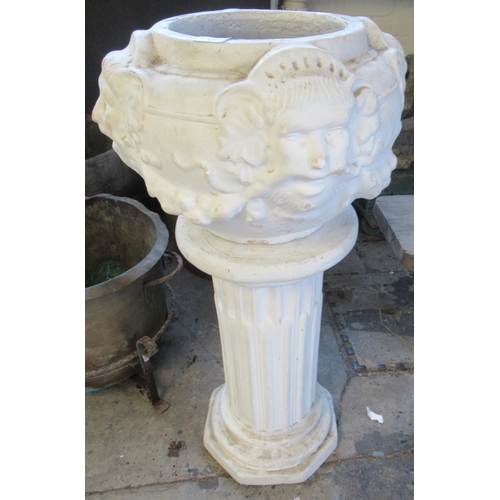 519 - Moulded composition pedestal planter with mask mounts. 86cm high approx. 
(B.P. 21% + VAT)