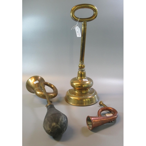 62 - Large brass half baluster shaped doorstop with loop handle, together with a brass bulb horn and a Fr... 