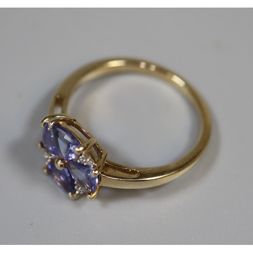 238 - 9ct gold tanzanite and diamond ring in flower head design.   Ring size L&1/2.  Approx weight 2.2 gra... 