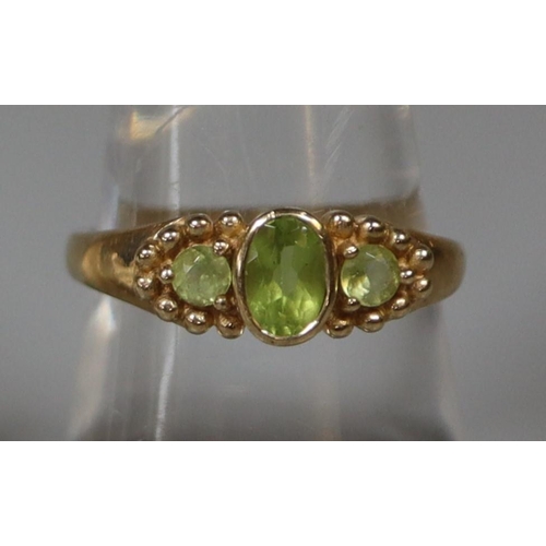 242 - 9ct gold three stone peridot ring.  Ring size P.  Approx weight 3 grams.
(B.P. 21% + VAT)