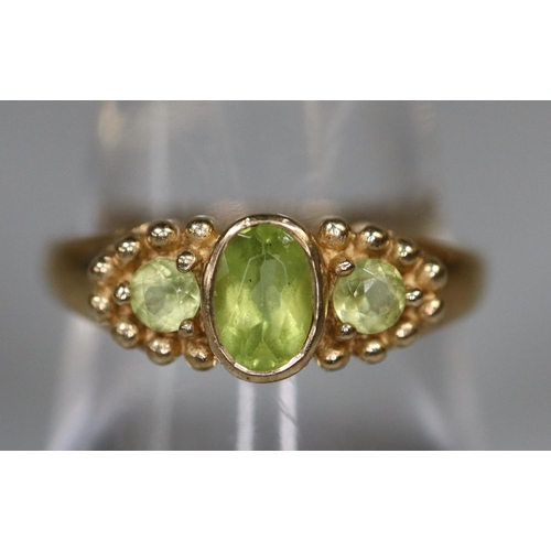 242 - 9ct gold three stone peridot ring.  Ring size P.  Approx weight 3 grams.
(B.P. 21% + VAT)