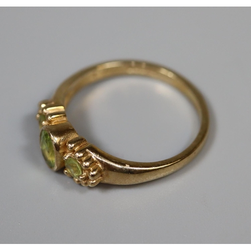 242 - 9ct gold three stone peridot ring.  Ring size P.  Approx weight 3 grams.
(B.P. 21% + VAT)