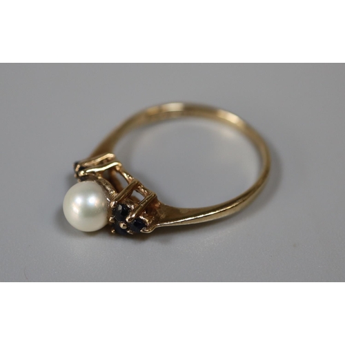 253 - 9ct gold cultured pearl and sapphire ring.  Ring size M.  Approx weight 1.6 grams.
(B.P. 21% + VAT)