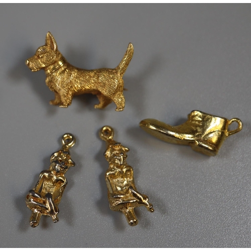 276 - Yellow metal dog brooch and three gold plated charms.
(B.P. 21% + VAT)