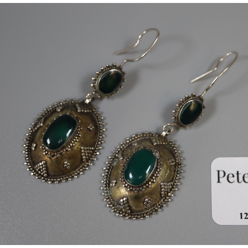 277 - Pair of white metal earrings decorated with granulation and set with green cabochon stones.  Approx ... 