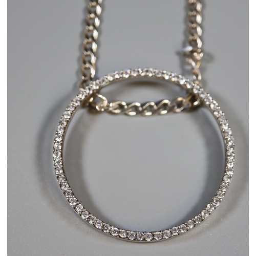 294 - Large silver circle pendant set with white stones on a silver chain.  Approx weight 25.78 grams.
(B.... 