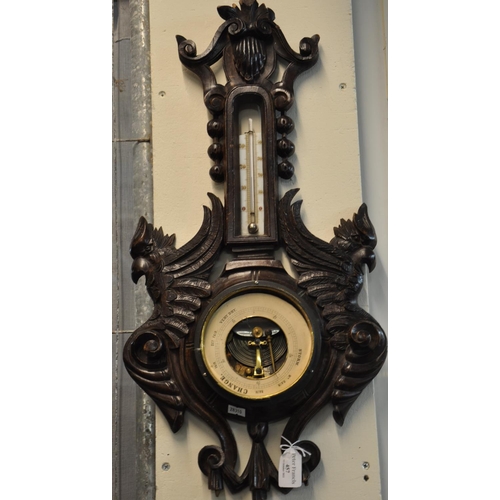 457 - Early 20th century ornate carved oak barometer with griffin mounts.  (B.P. 21% + VAT)