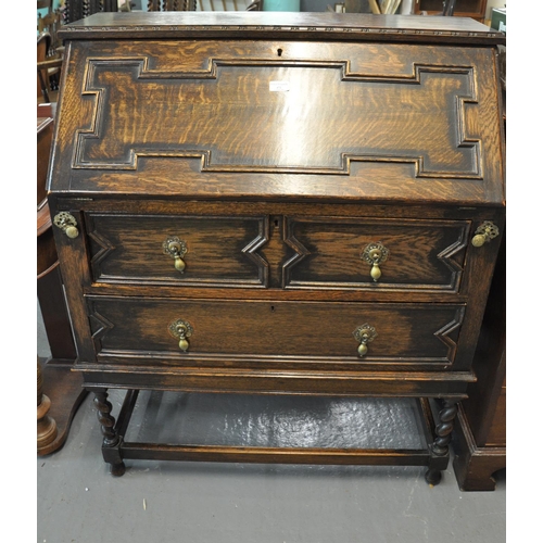 472 - Early 20th century oak Jacobean style fall front bureau having two long drawers on barley twist supp... 