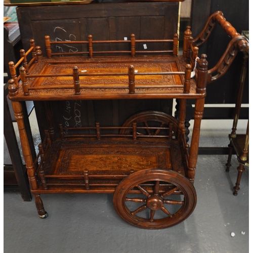 482 - Unusual Indian hardwood and brass inlaid two tier drinks trolley on eight spoke wheels.  (B.P. 21% +... 