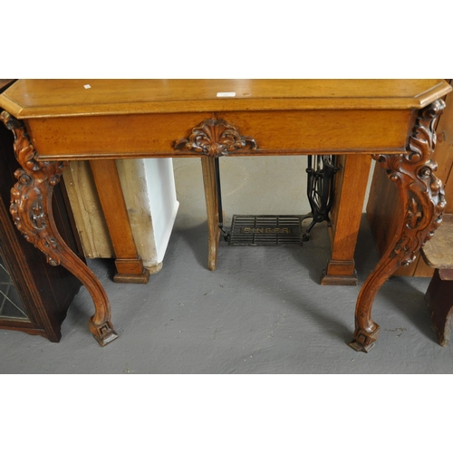 485 - Victorian oak console table, the molded shaped top above two drawers standing on ornate carved cabri... 