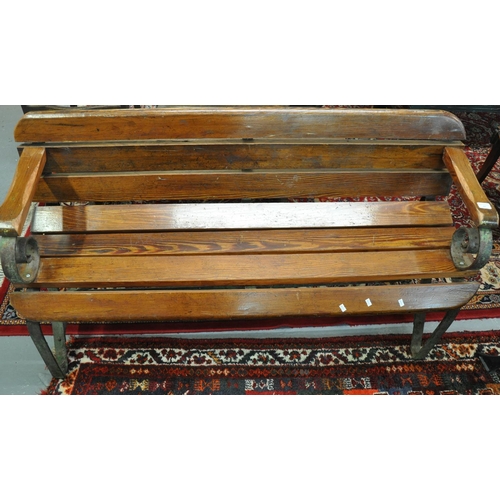 499 - Heavy pitch pine garden bench with cast iron frame.  (B.P. 21% + VAT)