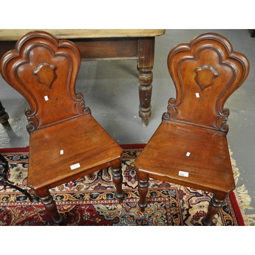 505 - Pair of Victorian mahogany hall chairs having cloud back moulded design, shaped moulded seats standi... 