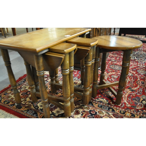 507 - Mid century oak side table, having three pullout drop leaf type tables, standing on wheels.  (B.P. 2... 