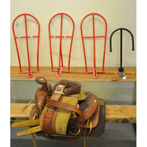 530 - Spanish leather horse saddle together with three metal hanging saddle racks and another similar.  (B... 