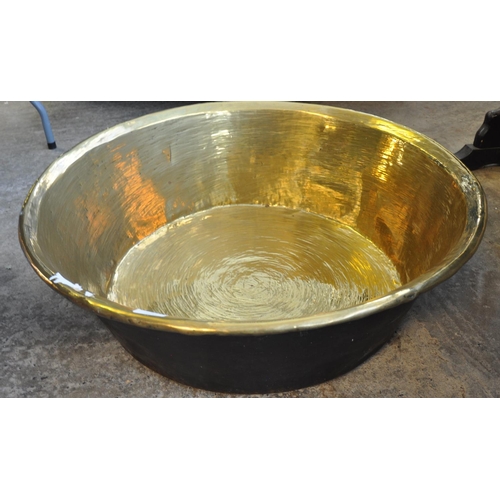 557 - Large 19th century brass pan, 76cm diameter approx.  (B.P. 21% + VAT)