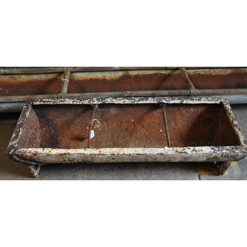 570 - Cast iron feeding trough together with another galvanised feeding trough and a drain hopper marked '... 