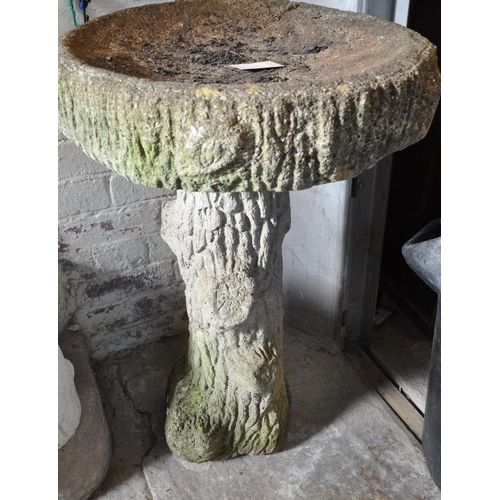 572 - A garden weathered bird bath, the pedestal in the form of a tree stump.   (B.P. 21% + VAT)