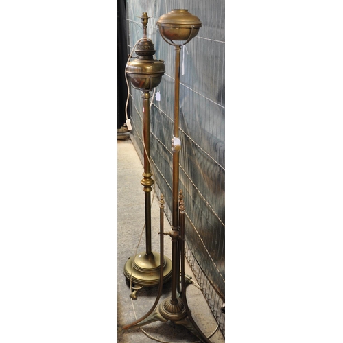 574 - Two similar 'Arts and Crafts' brass floor oil lamps, one now converted to electricity.  (2)   (B.P. ... 