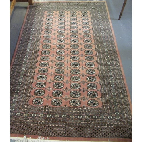 584 - Middle eastern design peach ground geometric carpet, the centre repeating gull design.  155x250cm ap... 