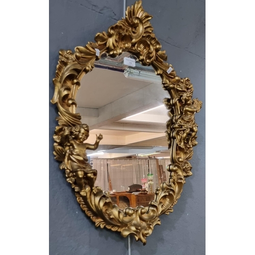 139 - Modern gilt framed cherub mounded oval mirror.  70x47cm approx.  (B.P. 21% + VAT)