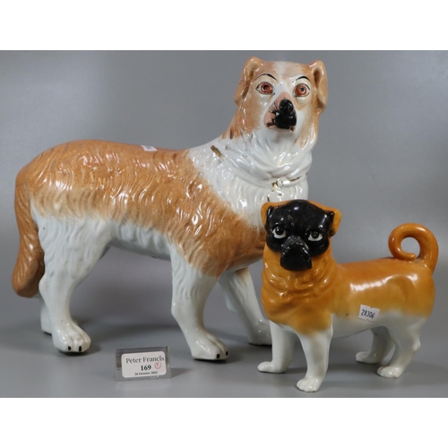 169 - Early 20th Century Staffordshire pottery fireside dog, with painted features, together with another ... 