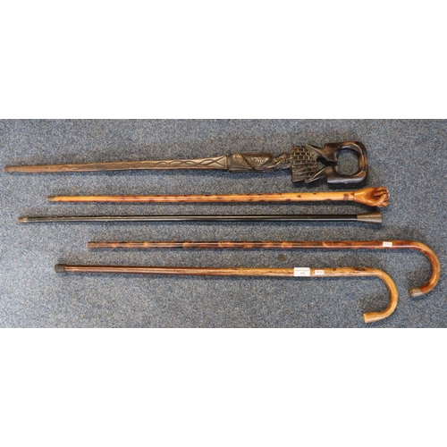 179 - Group of assorted walking sticks, to include: hardwood stick with clenched fist terminal carved with... 