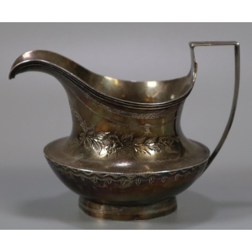 199 - George III silver baluster/helmet shaped cream jug with engraved foliate decoration.  London hallmar... 