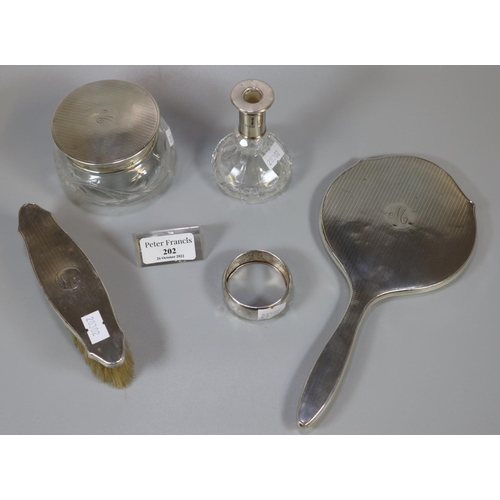 202 - Collection of assorted silver vanity items, to include: hand mirror, brush, jar and cover, together ... 