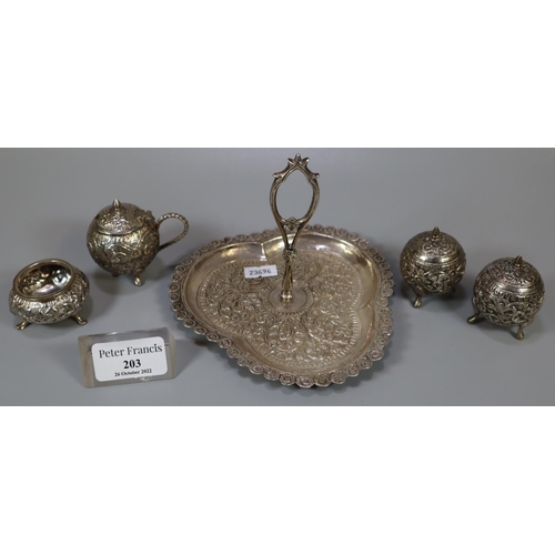 203 - Indian white metal condiment set, having two pepperettes, open salt and lidded mustard on a clover l... 