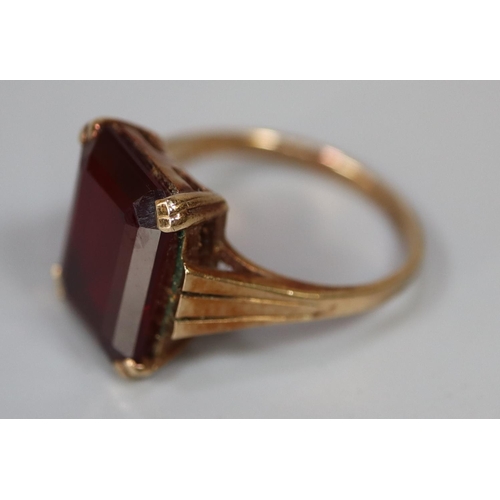 237 - 9ct gold dress ring set with a step cut red stone.  Ring size M & 1/2.  Approx weight 4.7 grams.
(B.... 