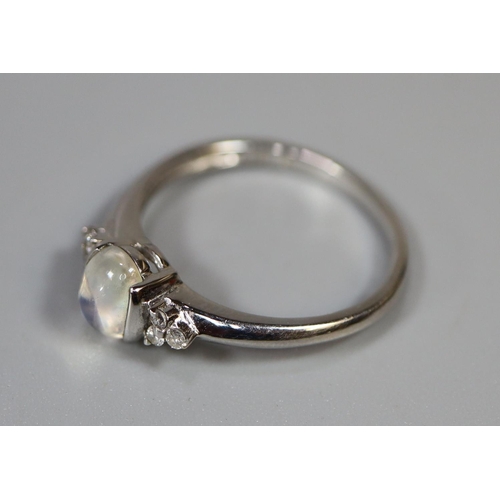 251 - 9ct white gold ring set with a moonstone and diamonds.  Ring size O & 1/2.  Approx weight 2.2 grams.... 