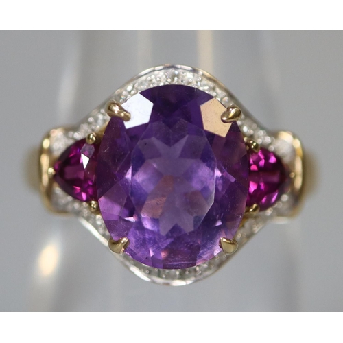 252 - 9ct gold ring set with purple stones and diamonds.  Ring size N.  Approx weight 3.4 grams.
(B.P. 21%... 