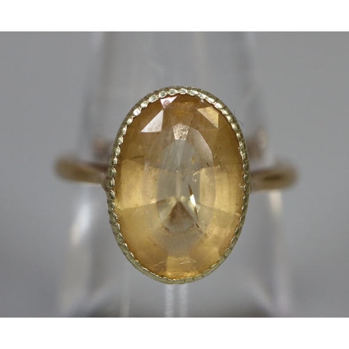 255 - 9ct gold dress ring set with an oval yellow stone.  Ring size M.  Approx weight 3.9 grams.
(B.P. 21%... 