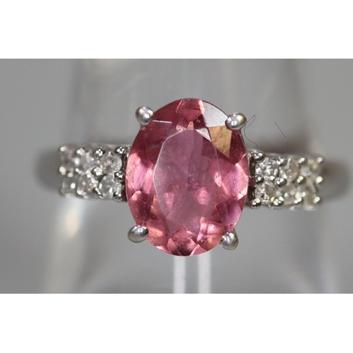 256 - 9ct white gold ring set with an oval pink stone and diamonds.  Ring size O.  Approx weight 2.8 grams... 